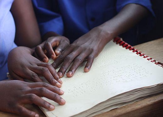 hands reading braille
