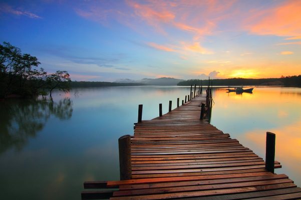 lake at sunrise with long dock