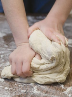 2 hands kneading bread