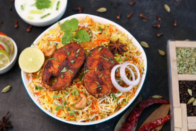 plate of biryani rice dish with fish on top