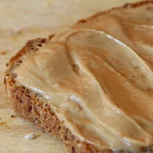 peanut butter spread thickly on brown bread