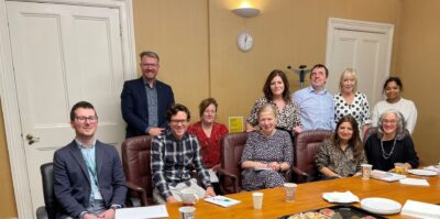 A dozen people around a conference table in Dublin after a conversation about accessibility